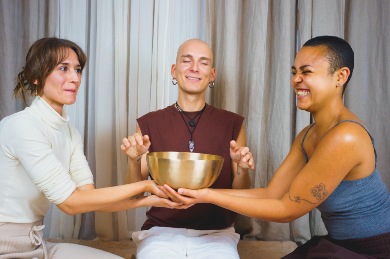 Passing a singing bowl in a group sound bath